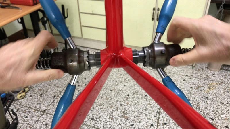 inserting bottom bracket tapping tool into bottom bracket